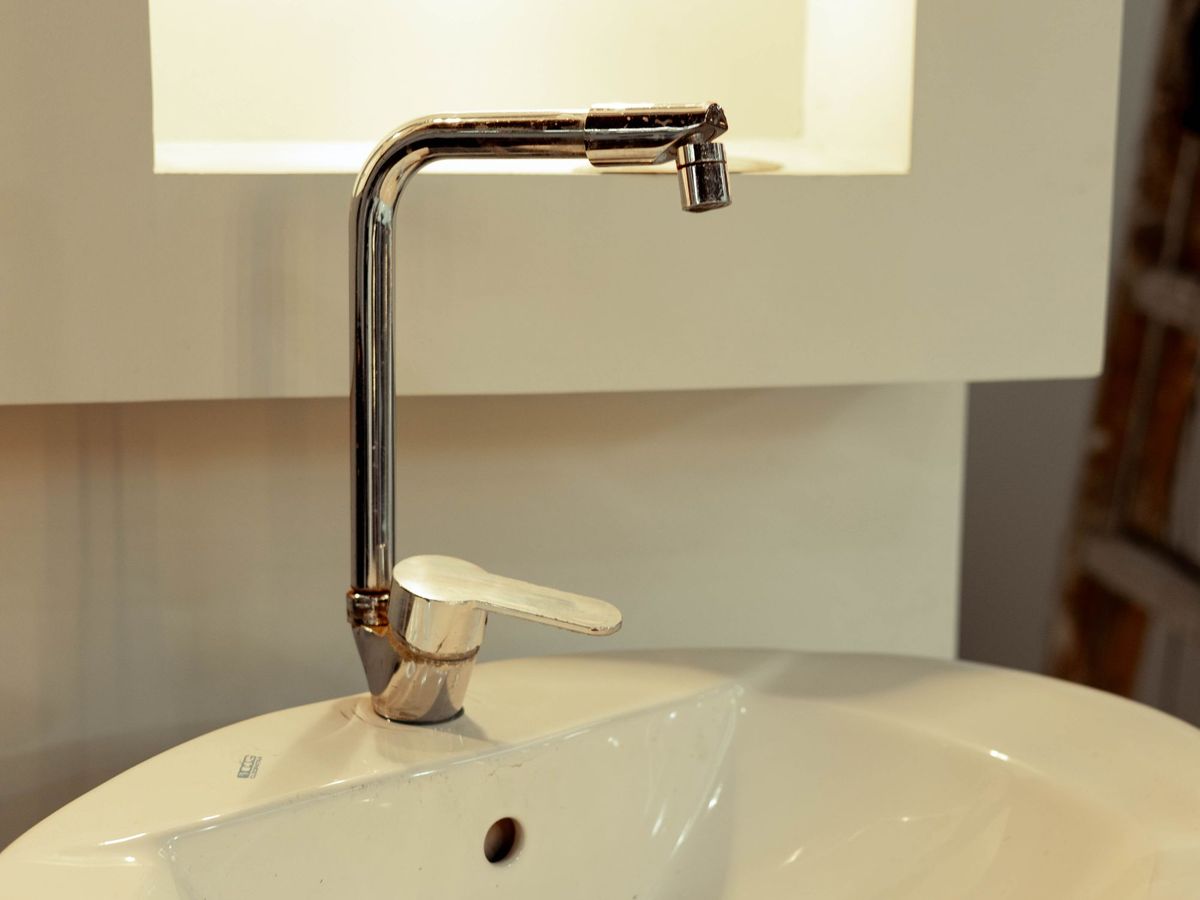 Modern bathroom vessel sink with a stainless steel faucet