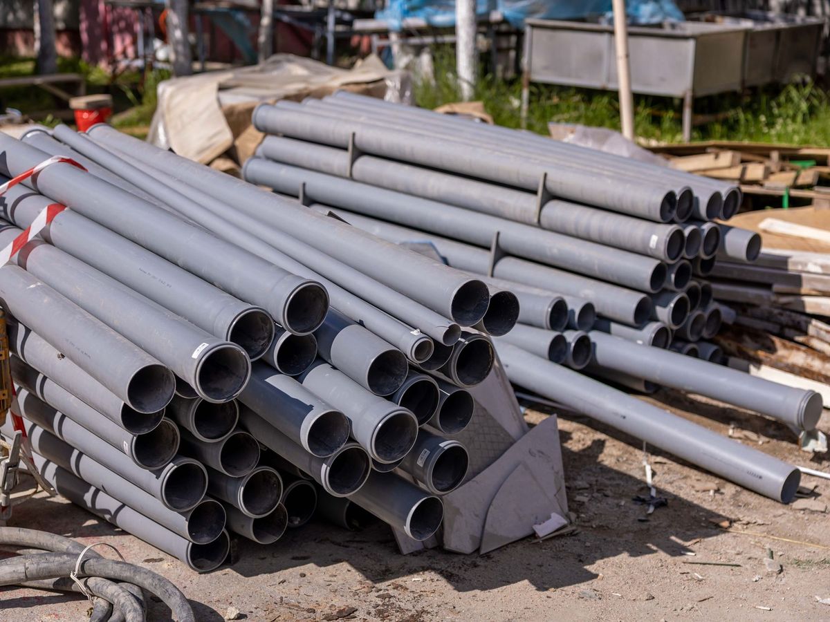 Stack of new PVC pipes on a job site