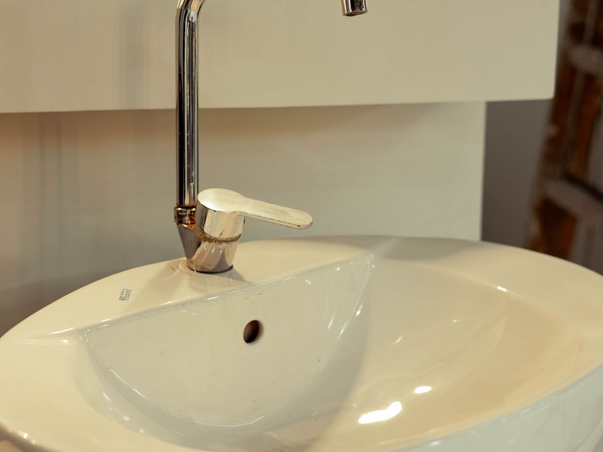 White vessel sink with a tall modern faucet
